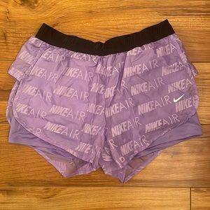 Nike Wmn running shorts. Purple. Large large. Never worn. Spandex shorts under